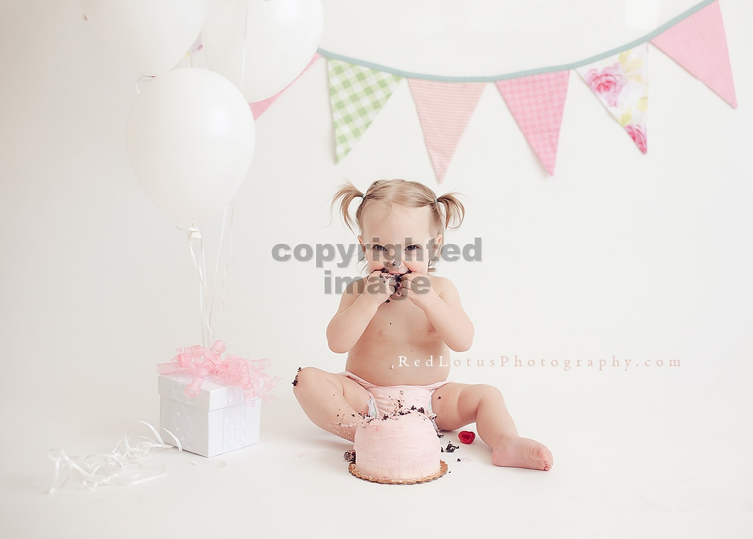 One year old toddler girl with smash cake