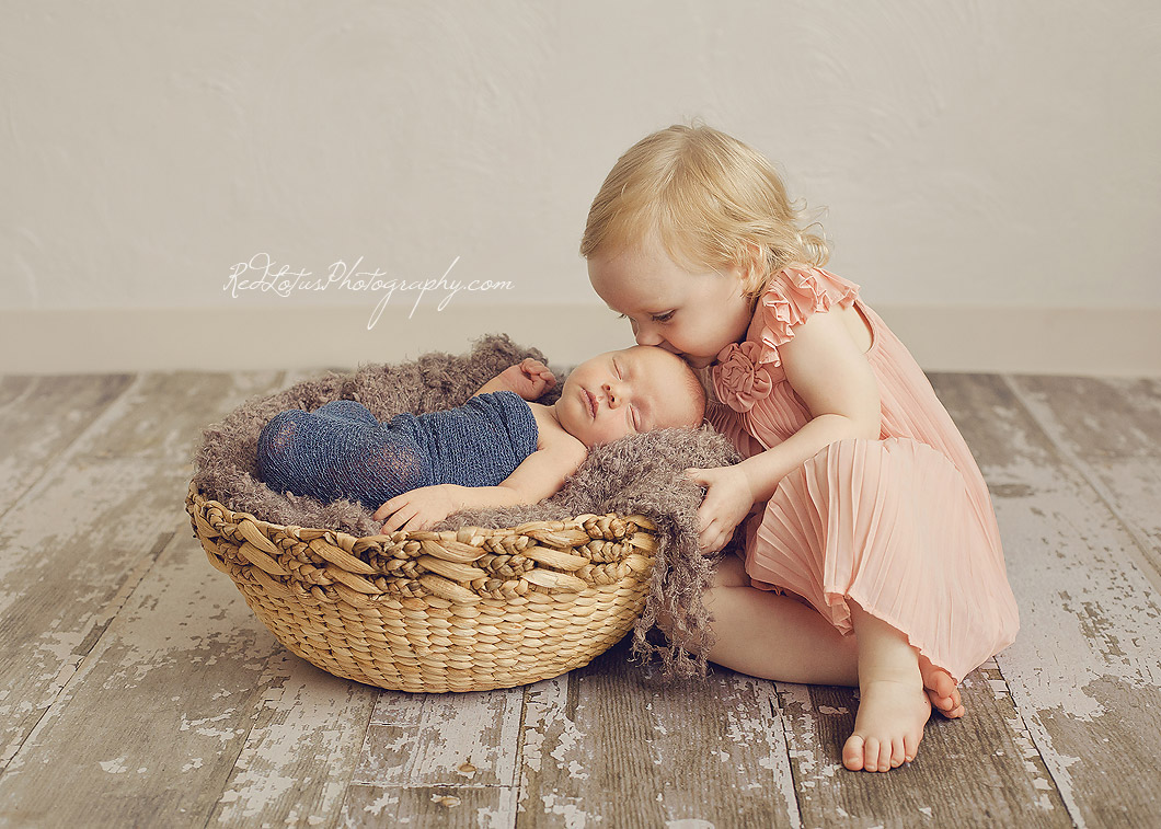 newborn siblings posing