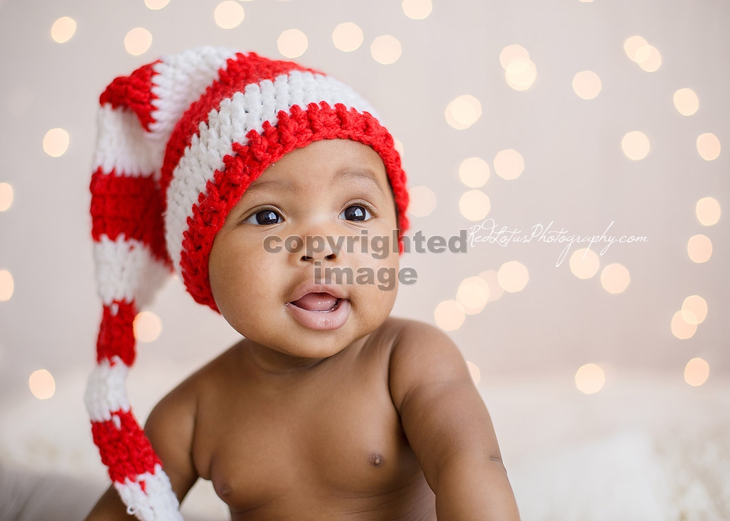 baby with twinkle light backdrop